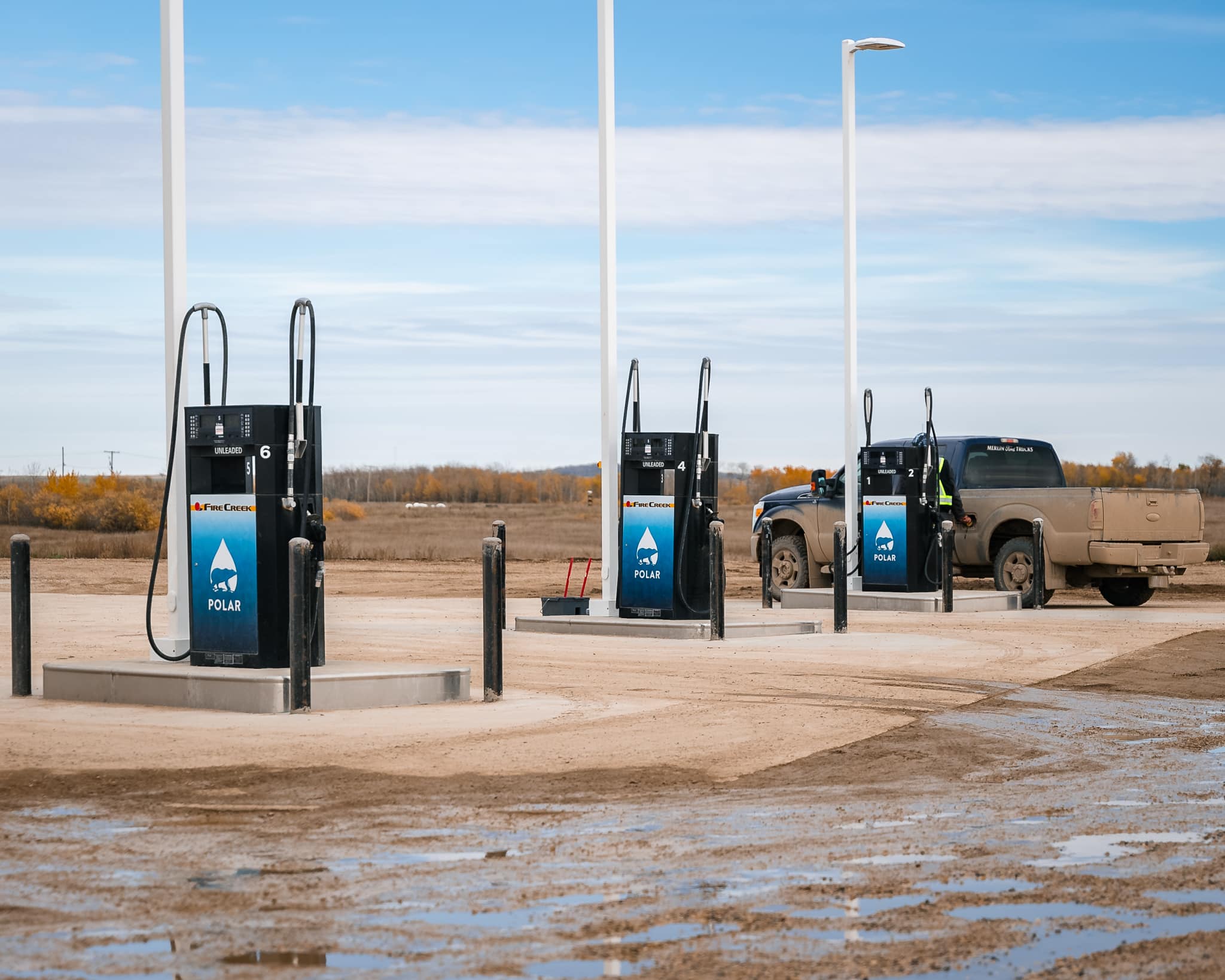 Gas pumps with a truck nearby.