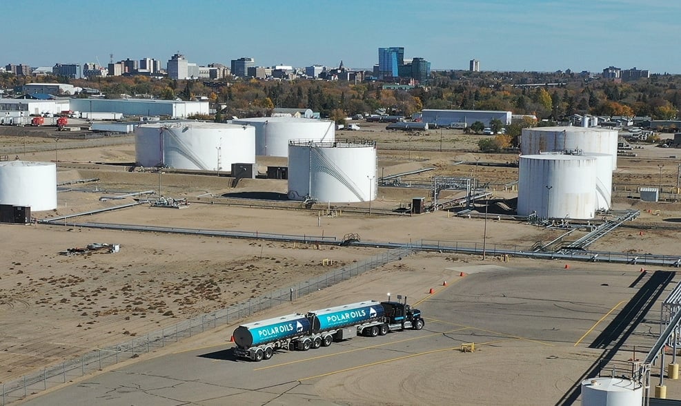 Oil tanks and delivery truck visible.