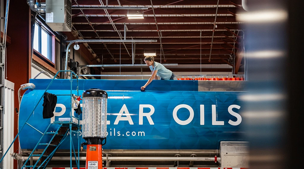 Person cleaning blue Polar oils tank