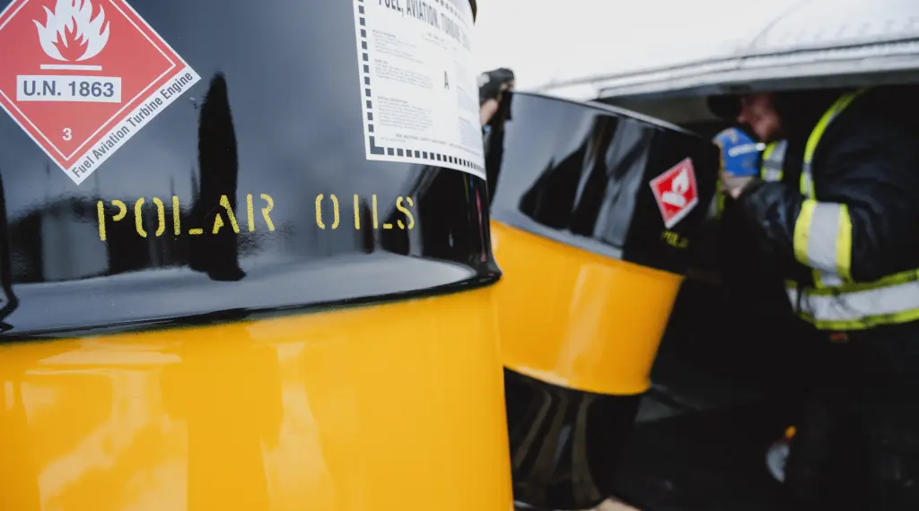 Black and yellow fuel drums labeled
