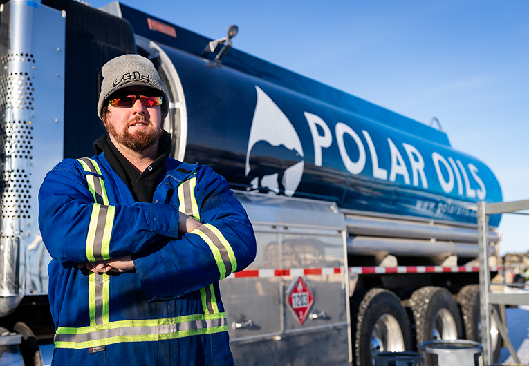 Polar Oils worker standing in front of a Clear diesel fuel delivery truck.