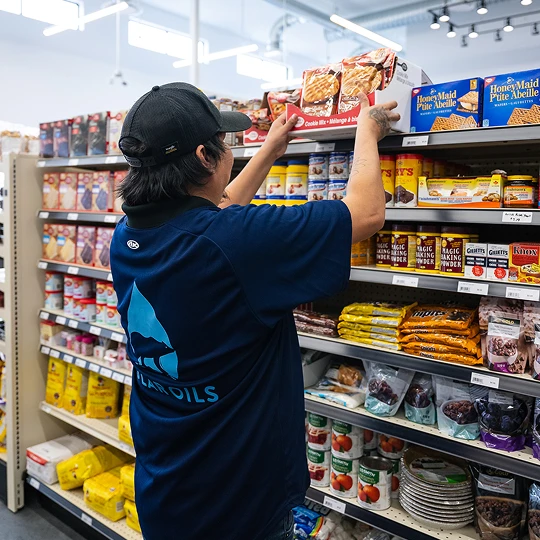 Person stocking shelves in grocery store
