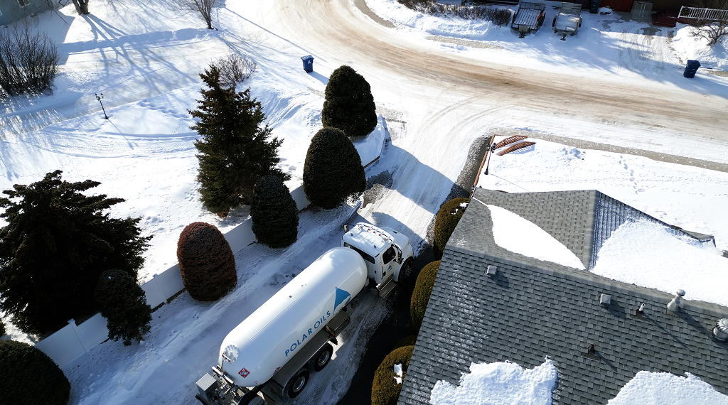 Oil delivery truck in snowy neighborhood