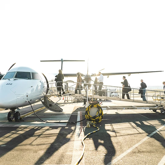 Passengers boarding a small aircraft
